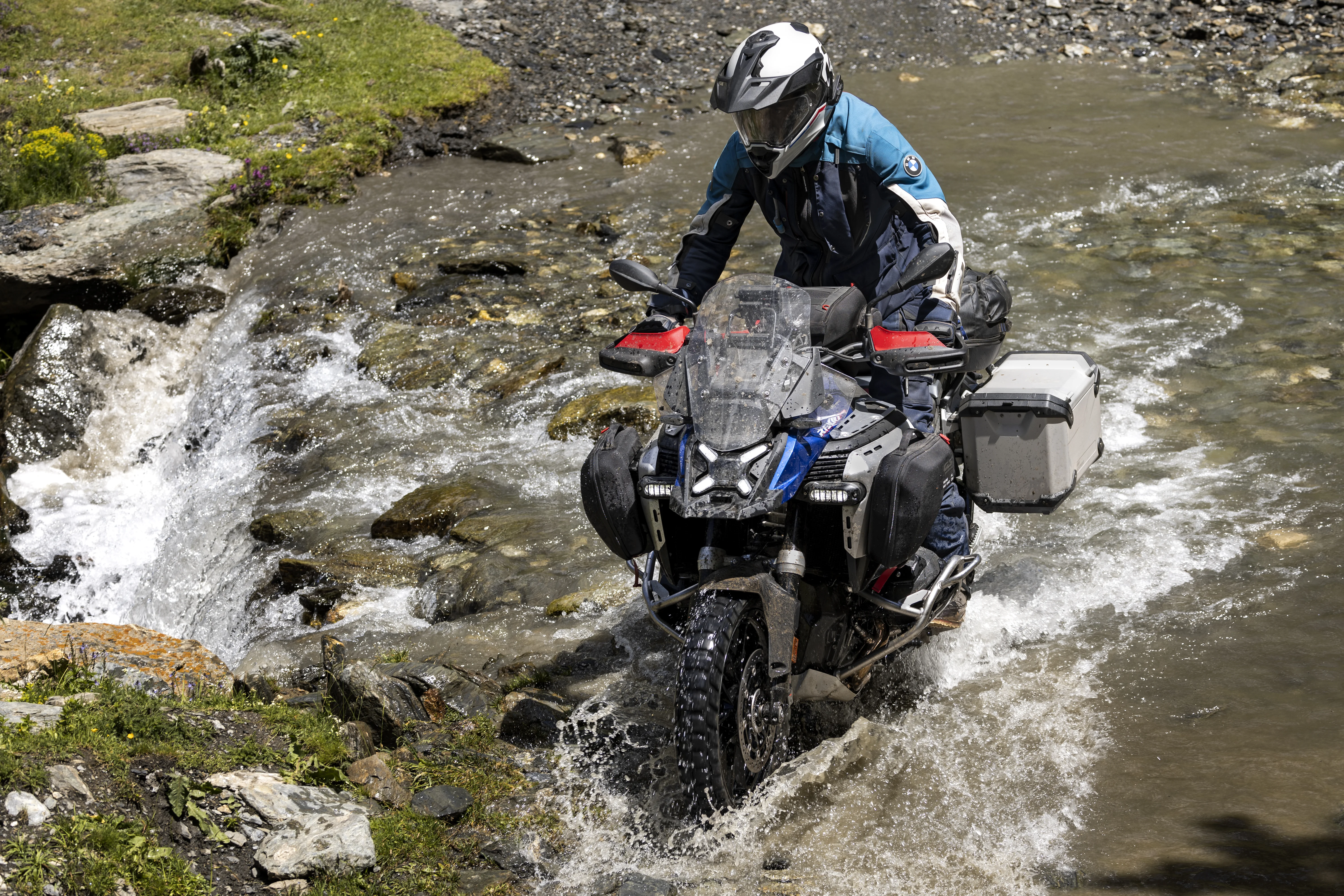 2026 BMW R 1300 GS Adventure crossing shallow water on a rocky off-road trail