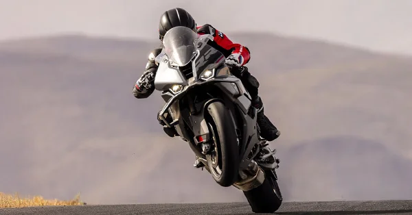 2026 BMW S 1000 RR leaned over on a racetrack in a performance riding scene.